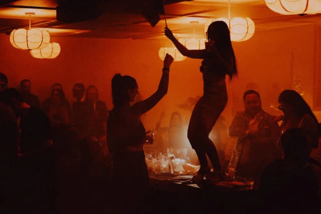 Dancer performing among guests under warm lighting at LAVO Party Brunch in Las Vegas
