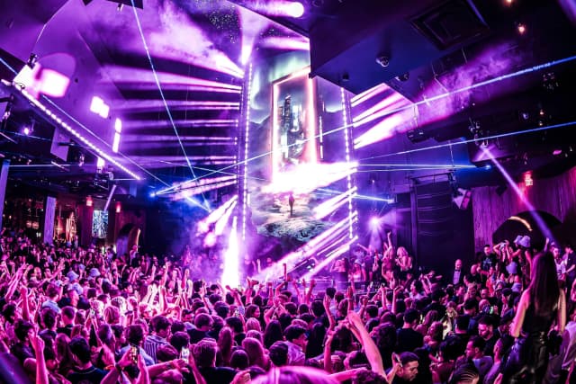 Marquee Nightclub Las Vegas — Dance floor beneath purple lights Marquee Nightclub Las Vegas — Dance floor beneath purple lights